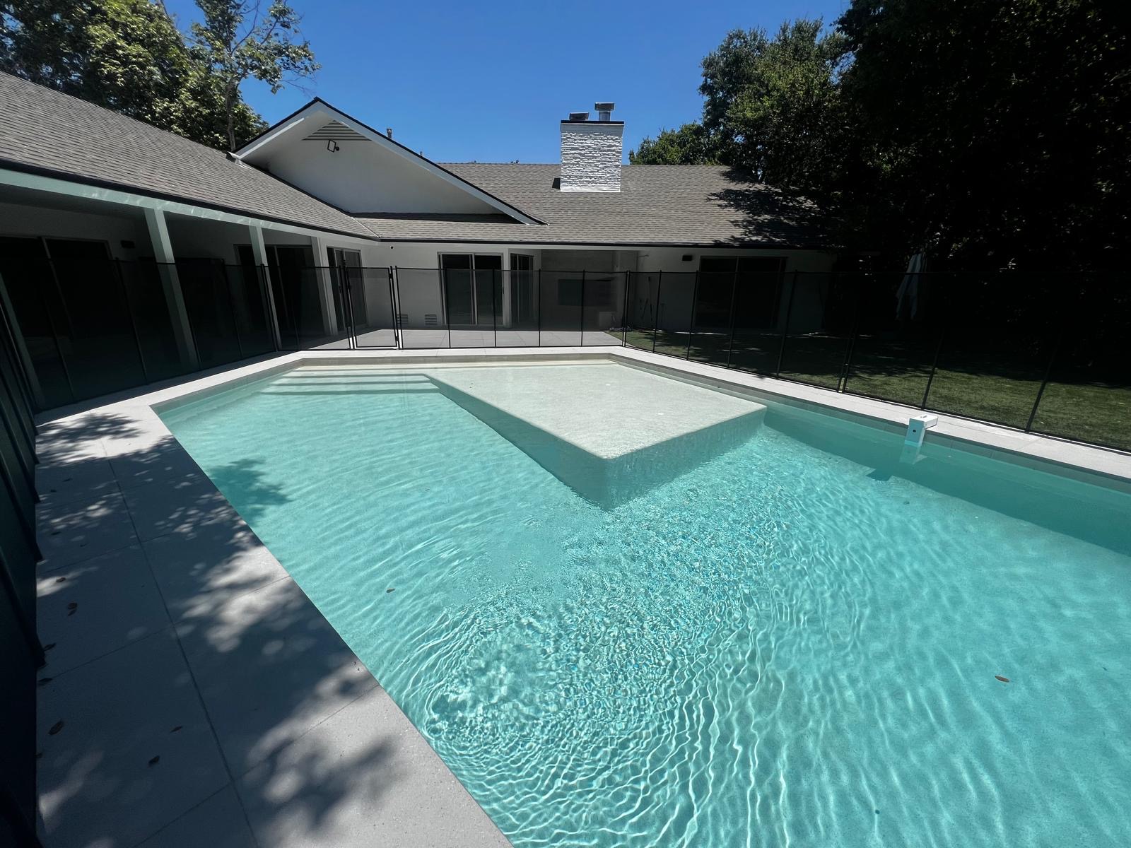 Modern remodeled swimming pool with sun shelf