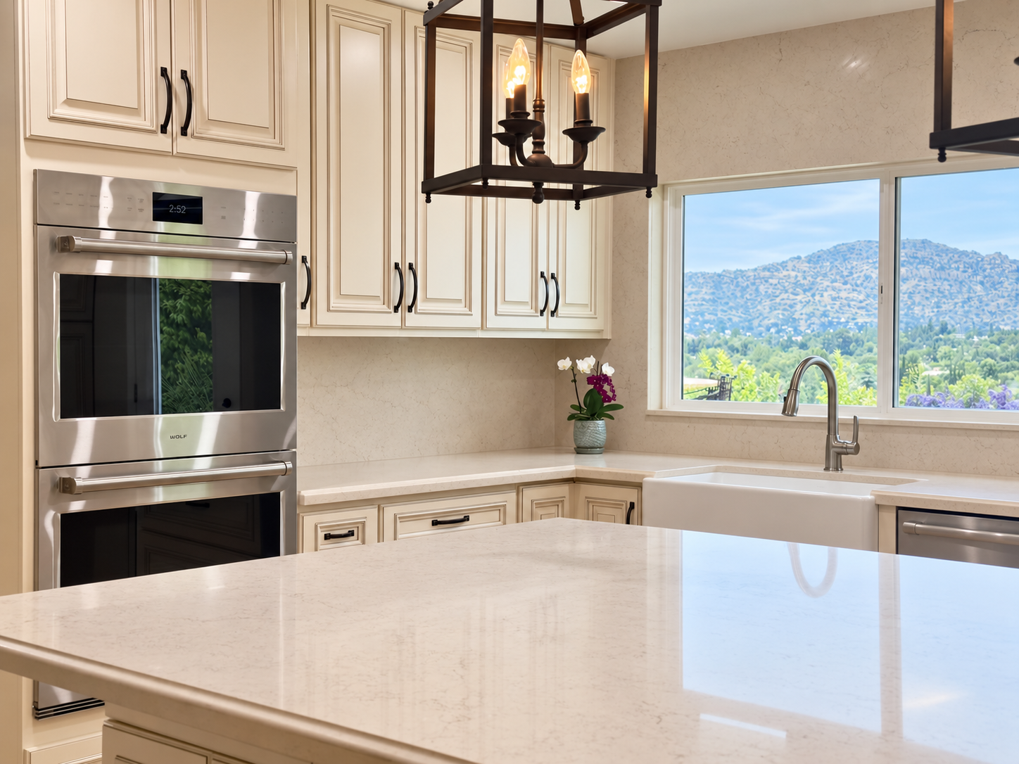 White kitchen with island and built-in ovens