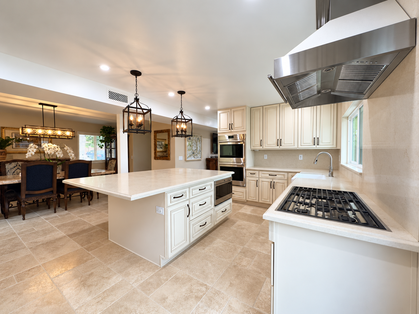 White kitchen with island and adjacent dining area
